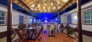 a dining room with tables and chairs on a balcony at Hostal Casa del Palmar in Santa Marta