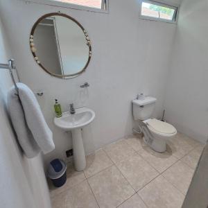 a bathroom with a toilet and a sink and a mirror at Hostal Casa del Palmar in Santa Marta +43 photos