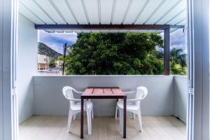 a table and chairs on a balcony with a window at Authentic Nest in La Gaulette +77 photos
