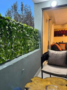 a balcony with a green wall with a chair at Noble Park Apartments in Kiserian