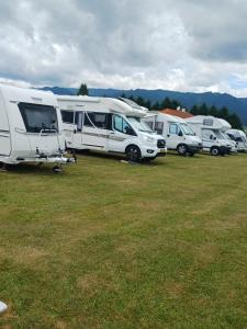 a group of rvs parked in a field at Camping Dorfer in Spielberg