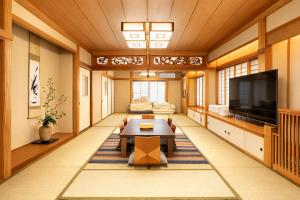 a living room with a table and a tv at 東京雅麗館 in Tokyo