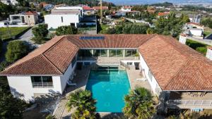 an aerial view of a house with a swimming pool at Lagos House in Braga