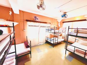 a dorm room with several bunk beds in it at Uhuru Peak Hostel in Moshi +4 photos