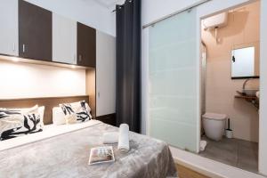 a bedroom with a bed and a sliding glass door at Hostal Sant Antoni in Barcelona +21 photos