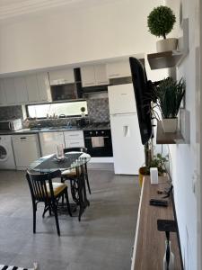 a kitchen with a table and a tv in it at Work and Wave cosy studio at La Marsa in Douar el Hafey +5 photos