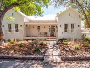a white house with a fence at House Erens By Die Bos in Stellenbosch