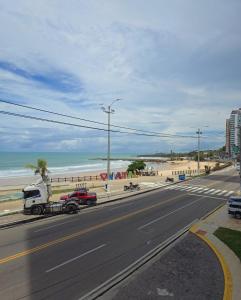 a road with a truck parked on the beach at Apartamento Vista Mar Belli Golden tower in Natal