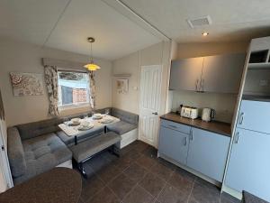a kitchen and dining room with a table and a kitchen and a kitchen at Caravan 607 in Clacton-on-Sea +4 photos