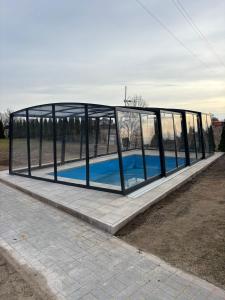 a glass house with a pool in it at Kotwica in Jezierzany