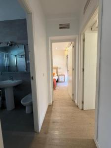 a hallway of a bathroom with a sink and a toilet at Villa puerto marina beach in Benalmádena
