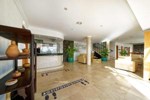 a large living room with a staircase in a house at BLUESEA El Dorado in Puerto del Carmen