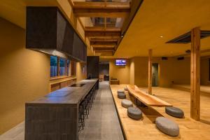 a large room with a long counter with benches at Nui in Minamiawaji
