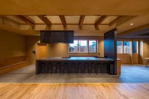 a large kitchen with a large black island in a room at Nui in Minamiawaji