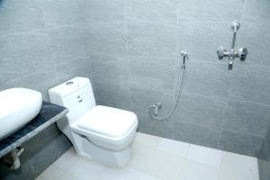 a bathroom with a toilet and a shower at The Charlie Backpackers in New Delhi