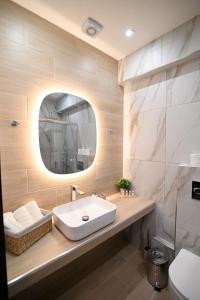 a bathroom with a sink and a mirror at Efanton 3 in Larisa +25 photos
