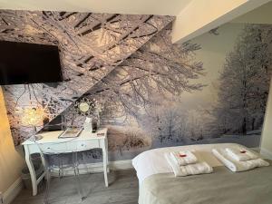 a bedroom with a bed and a desk and a wall at All Seasons Bed & Breakfast - Adults Only in Weston-super-Mare