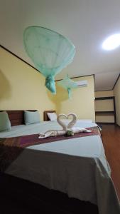 a room with a bed with a glass bowl on top of it at Riverside Bungalow Don Det in Don Det