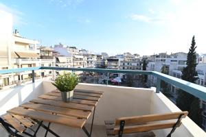 a balcony with two chairs and a table with a view at Efanton 3 in Larisa