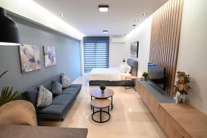 a living room with a couch and a bed at Efanton 3 in Larisa