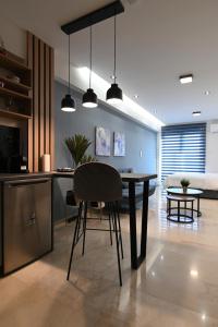 a kitchen and dining room with a table and chairs at Efanton 3 in Larisa