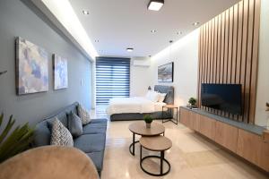 a living room with a couch and a bed at Efanton 3 in Larisa