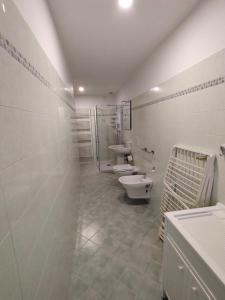 a white bathroom with two toilets and a sink at Oasi del Sole in Cupra Marittima +10 photos