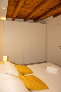 a bedroom with a large bed with white cabinets at Dimora del Borgo in Lovere +49 photos