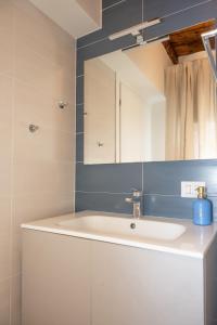 a bathroom with a sink and a mirror at Dimora del Borgo in Lovere