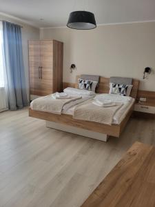 a bedroom with a large bed in a room at Къща за гости-Ганеви in Zmeitsa