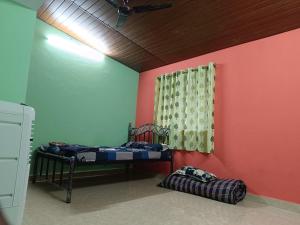 a room with two bunk beds and a window at Sheshatara Homestay in Honāvar