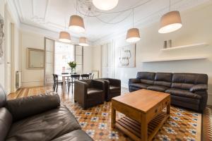 a living room with leather furniture and a table at SibsBcn- Rambla- Family Friends Business Central in Barcelona