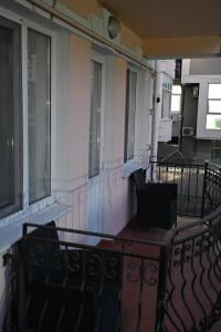 a balcony with a table and chairs on a building at Hotel Nicholas in Chişinău