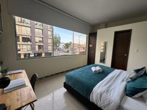 a bedroom with a bed with two stuffed animals on it at Tu Hotel Chía in Chía