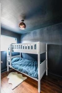 a white bunk bed in a blue room at Bold Coastal Retreat with Boudoir Interiors, Felpham Village in Bognor Regis