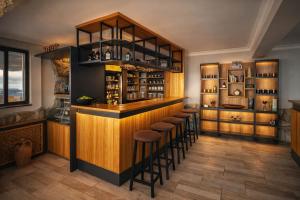 a bar with a row of stools in a room at Gokyuzu Hotel in Edremit