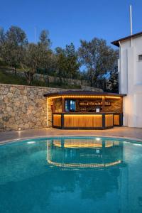 a swimming pool in front of a building at Gokyuzu Hotel in Edremit