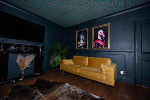 a living room with a couch and a tv at Bold Coastal Retreat with Boudoir Interiors, Felpham Village in Bognor Regis