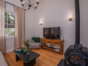 a living room with a television and a table at House Erens By Die Bos in Stellenbosch