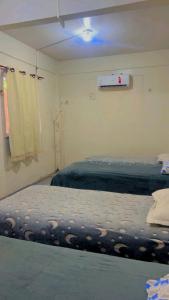 a bedroom with two beds and a window at Hostel Teresina in Teresina +14 photos