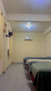 a row of beds in a room with a camera at Hostel Teresina in Teresina