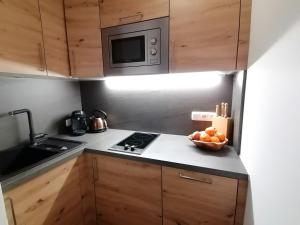 a small kitchen with a bowl of fruit on the counter at Haus Ditzer - Villa Theresia in Zell am See +29 photos