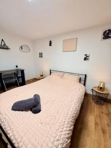 a bedroom with a bed with a blanket on it at Chez Niko in Martigues