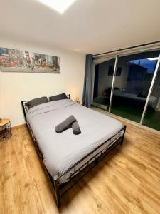 a large bed in a room with a large window at Chez Niko in Martigues