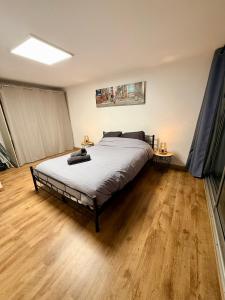 a bedroom with a bed and a wooden floor at Chez Niko in Martigues +15 photos