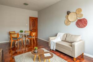 a living room with a couch and a table at Apartamento Canto da Chaco | by Aquarela Stays in Belém