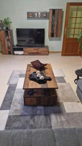 a living room with a table with a bird on it at Martina in Saint-Vith