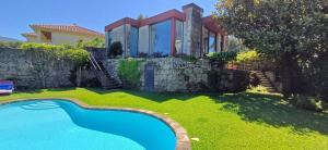 a house with a swimming pool in the yard at Bean House in Vila Nova de Cerveira