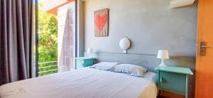 a bedroom with a bed and a window at Bean House in Vila Nova de Cerveira