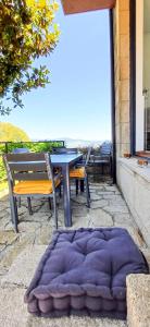 a purple rug sitting on the ground next to a table at Bean House in Vila Nova de Cerveira